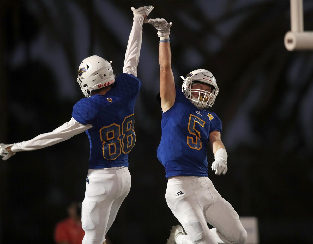 Tanner Ciok (5) celebrates his touchdown with Fountain Valley teammate Blake Anderson in the first half of a nonleague game against Woodbridge on Thursday at Huntington Beach High.