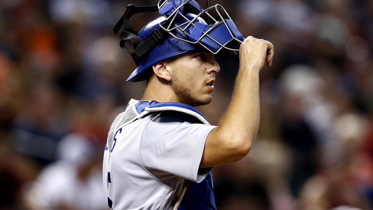 Dodgers catcher Austin Barnes lowers his mask during the fourth inning against the Arizona Diamondbacks on Aug. 30.