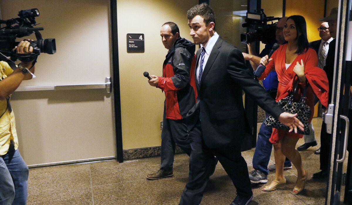 Johnny Manziel leaves the Frank Crowley Courts Building in Dallas on Nov. 17. Manziel has reached a deal with prosecutors for the conditional dismissal of a domestic assault case involving his former girlfriend.