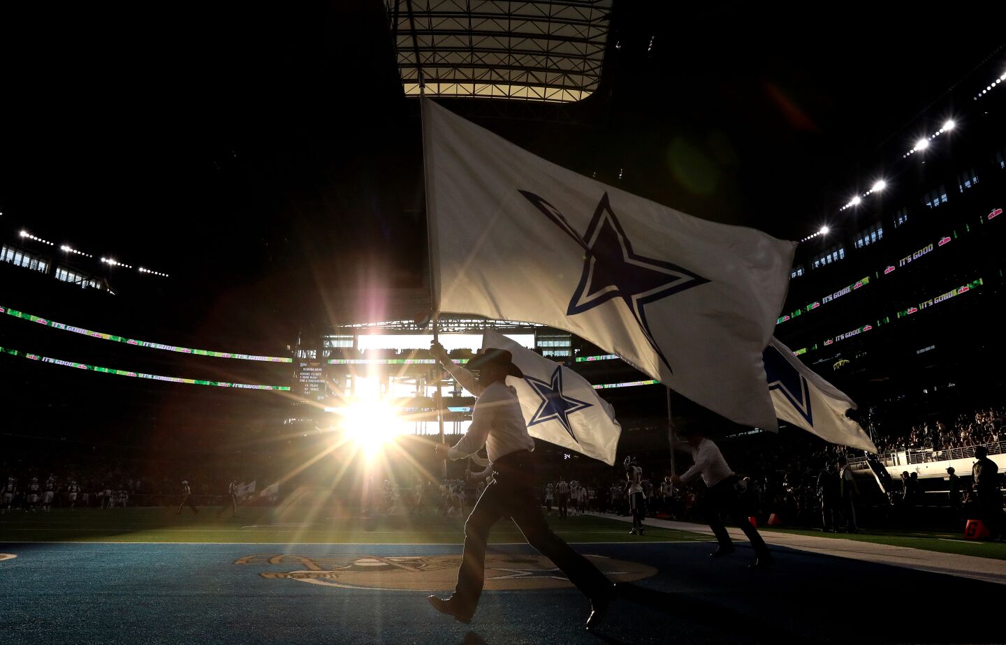 The Dallas Cowboys flag team runs onto the field after a second-quarter touchdown.