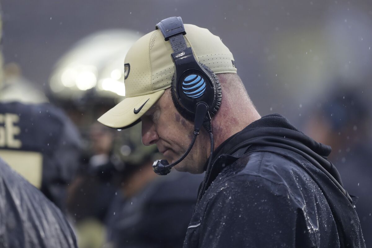 Purdue coach Jeff Brohm coaches in the rain
