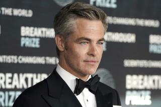 A closeup of Chris Pine's face showing the top of his tuxedo and black tie