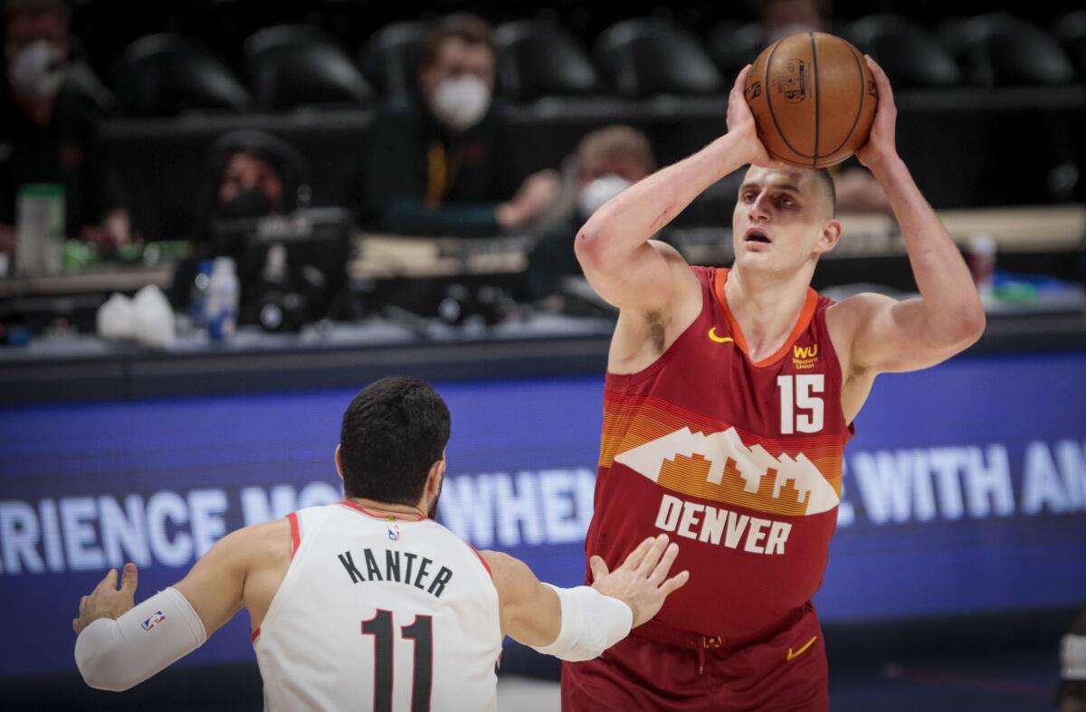 Denver Nuggets center Nikola Jokic shoots over Portland Trail Blazers center Enes Kanter.