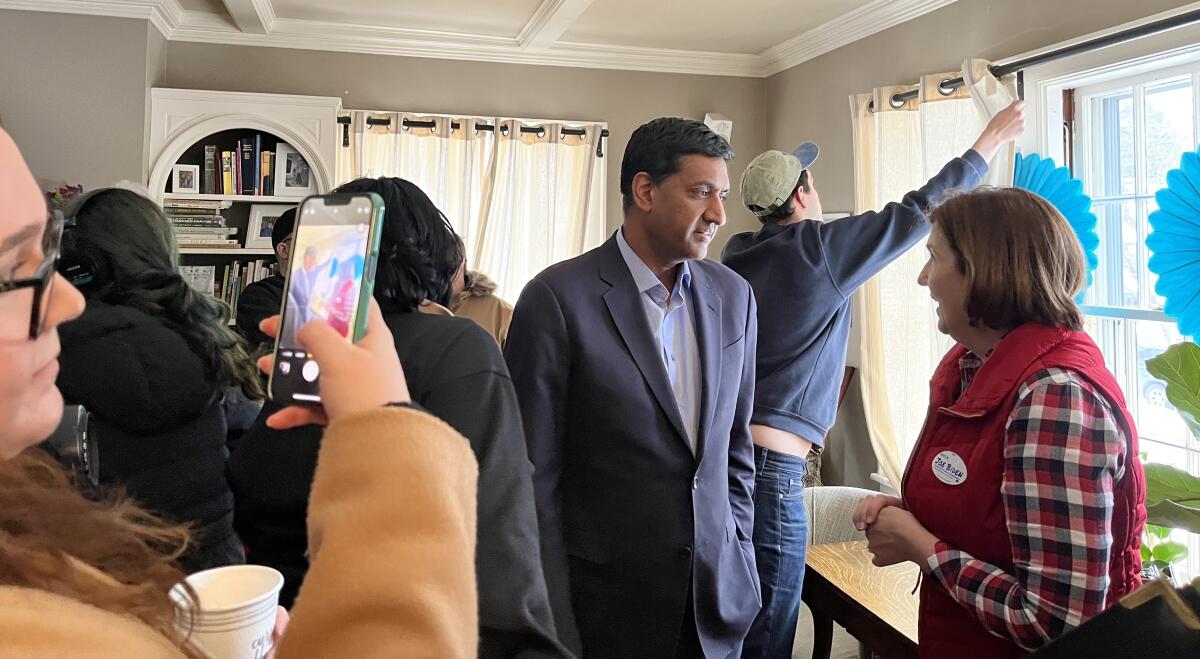 Rep. Ro Khanna talks to Cinde Warmington, who serves on New Hampshire's Executive Council and is running for governor. 