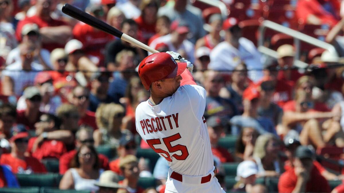 The Cardinals' Stephen Piscotty (55) follows through on a solo home run against the Miami Marlins in the fifth inning of a baseball game, Sunday, Aug. 16, 2015, at Busch Stadium in St. Louis.