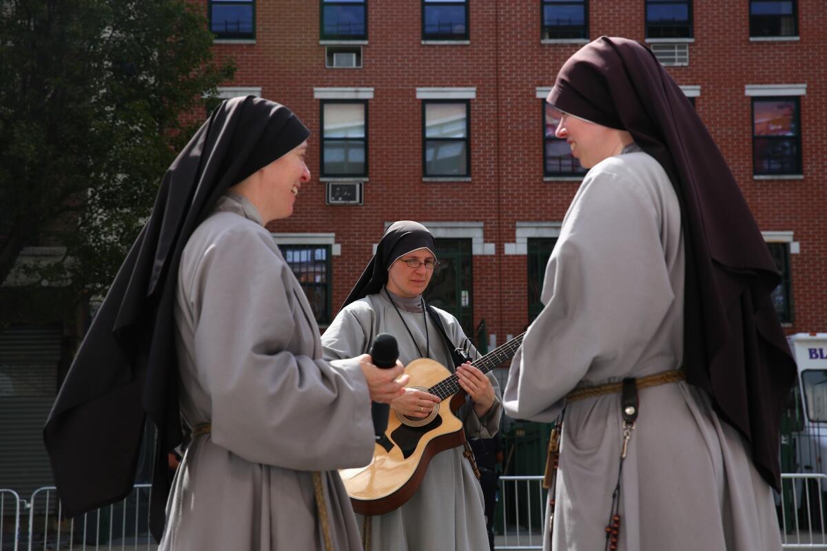 Nuns set up sound equipment outside prior to Pope Francis visiting Our Lady Queen of Angels School in New York City. (Photo by Eric Thayer-Pool/Getty Images) *