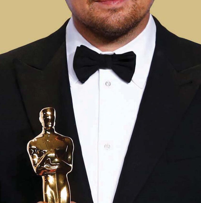 An actor holding an Academy Award.