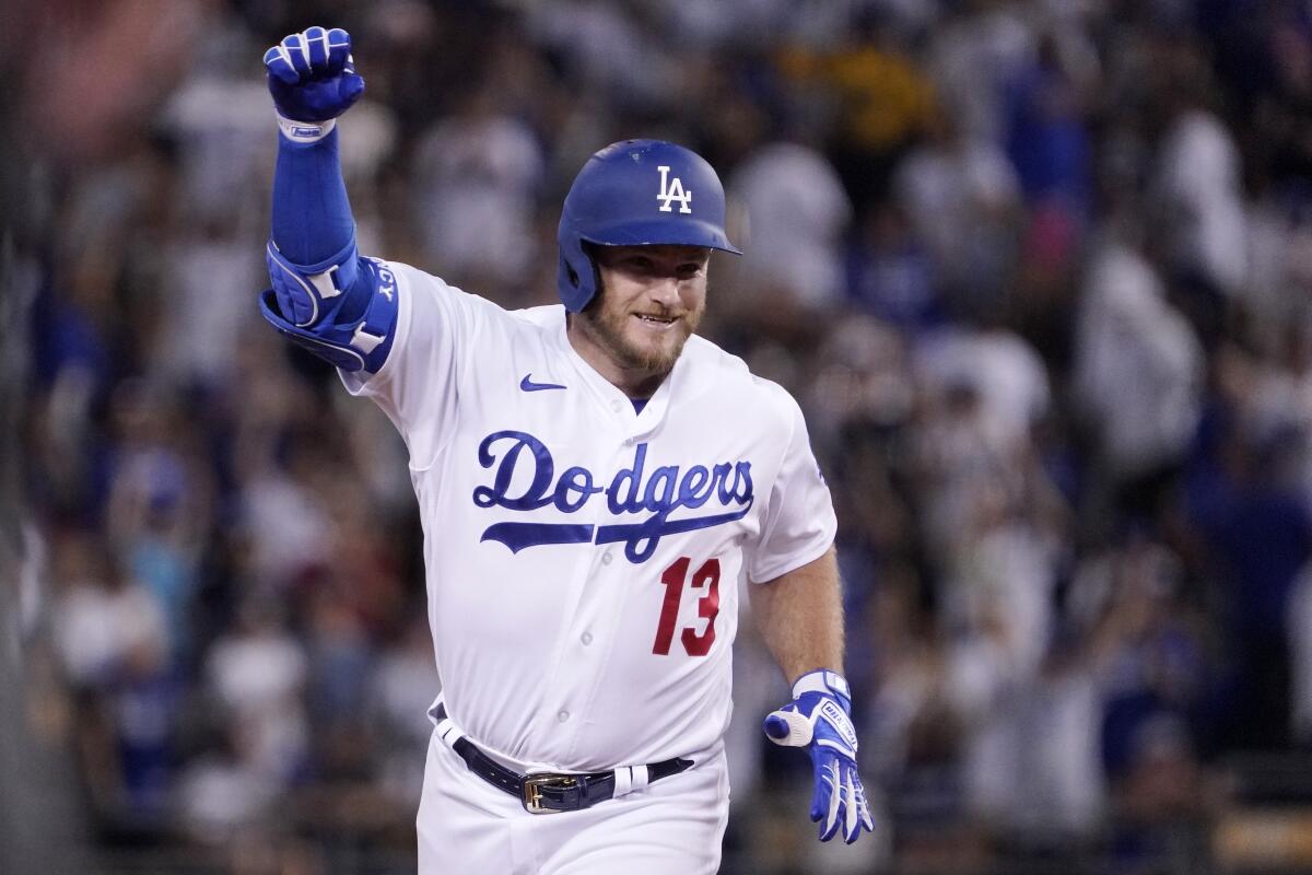 Los Angeles Dodgers' Max Muncy gestures as he rounds their after hitting a three-run home run during the fifth inning of a baseball game against the San Diego Padres Saturday, Aug. 6, 2022, in Los Angeles. (AP Photo/Mark J. Terrill)
