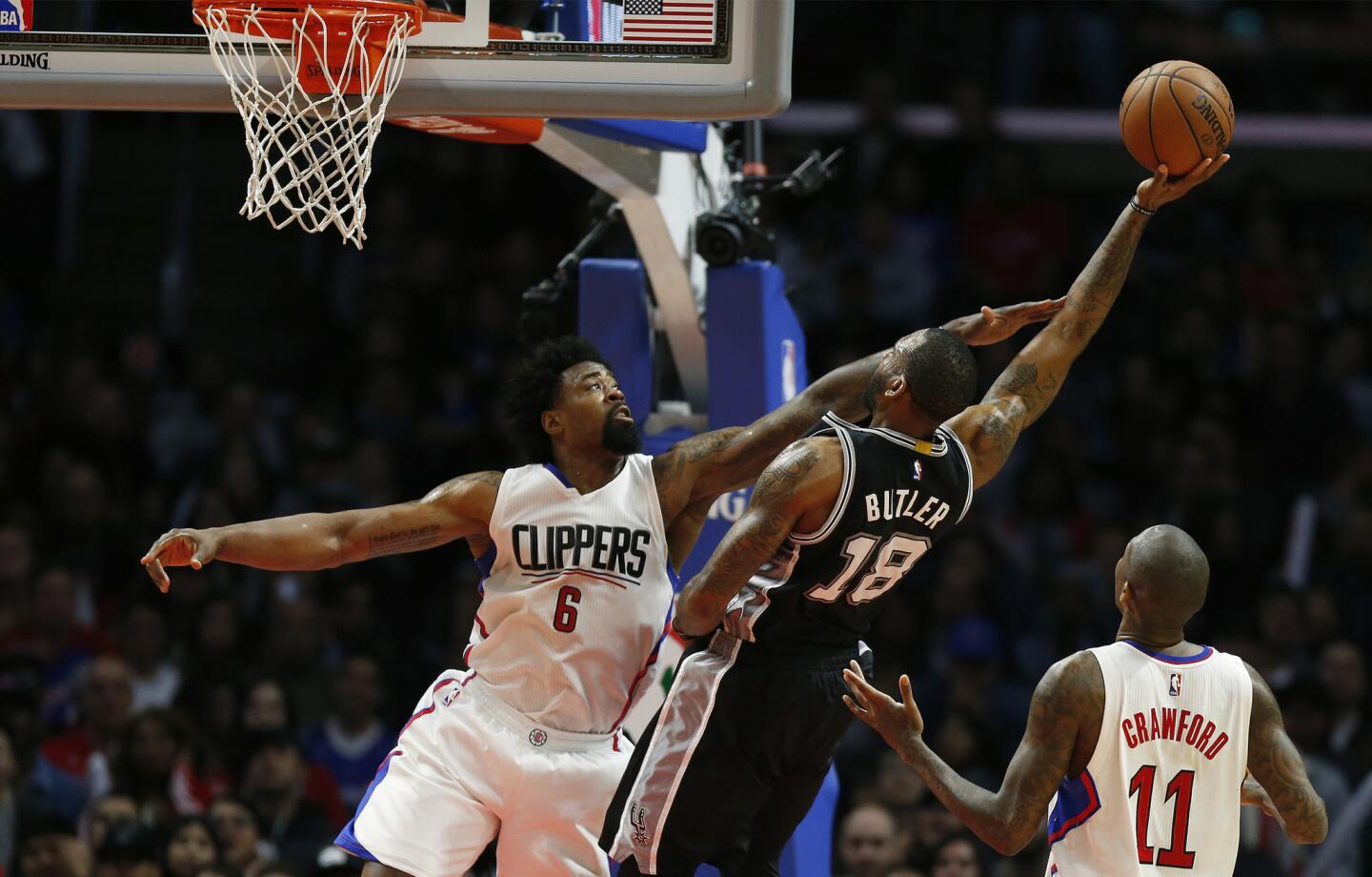 Clippers center DeAndre Jordan (6) forces Spurs forward Rasual Butler into an awkward shot during the second half Thursday night at Staples Center.