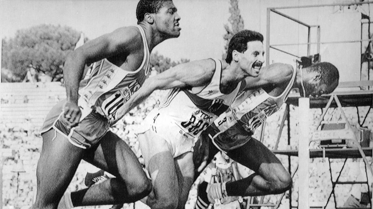 Edwin Moses, right, wins the 400-meter hurdle event at the World Track and Field Championships in Rome in 1987.