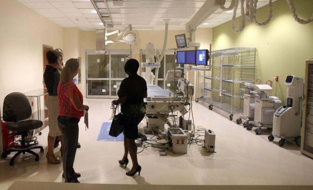 Residents tour Methodist Olive Branch Hospital's heart catheterization area after the grand opening ceremony in Olive Branch, Miss.