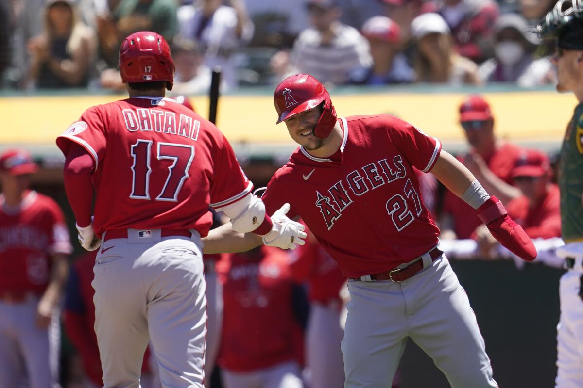 The Angels' Shohei Ohtani celebrates with Mike Trout after hitting a two-run homer May 15, 2022.