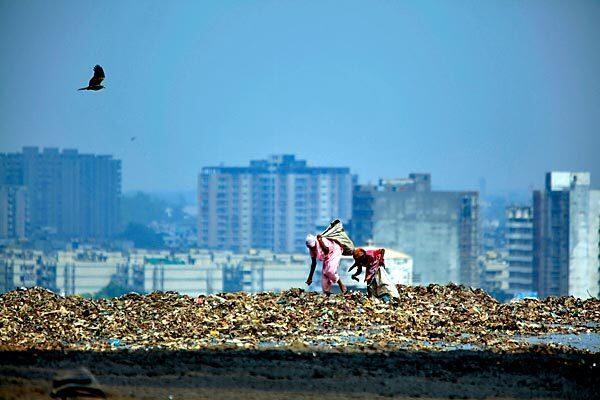 Rag pickers scavenge for food and recyclables at New Delhi's 70-acre Ghazipur landfill. The city produces about 9,200 tons of trash daily, up 50% from 2007. The garbage is expected to double by 2024, leaving Ghazipur and two other landfills overflowing.