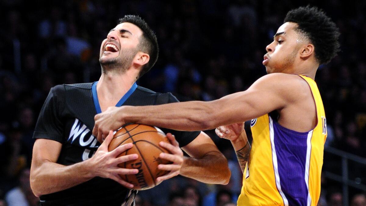 Lakers guard D'Angelo Russell fouls Timberwolves guard Ricky Rubio in the first quarter Wednesday night.
