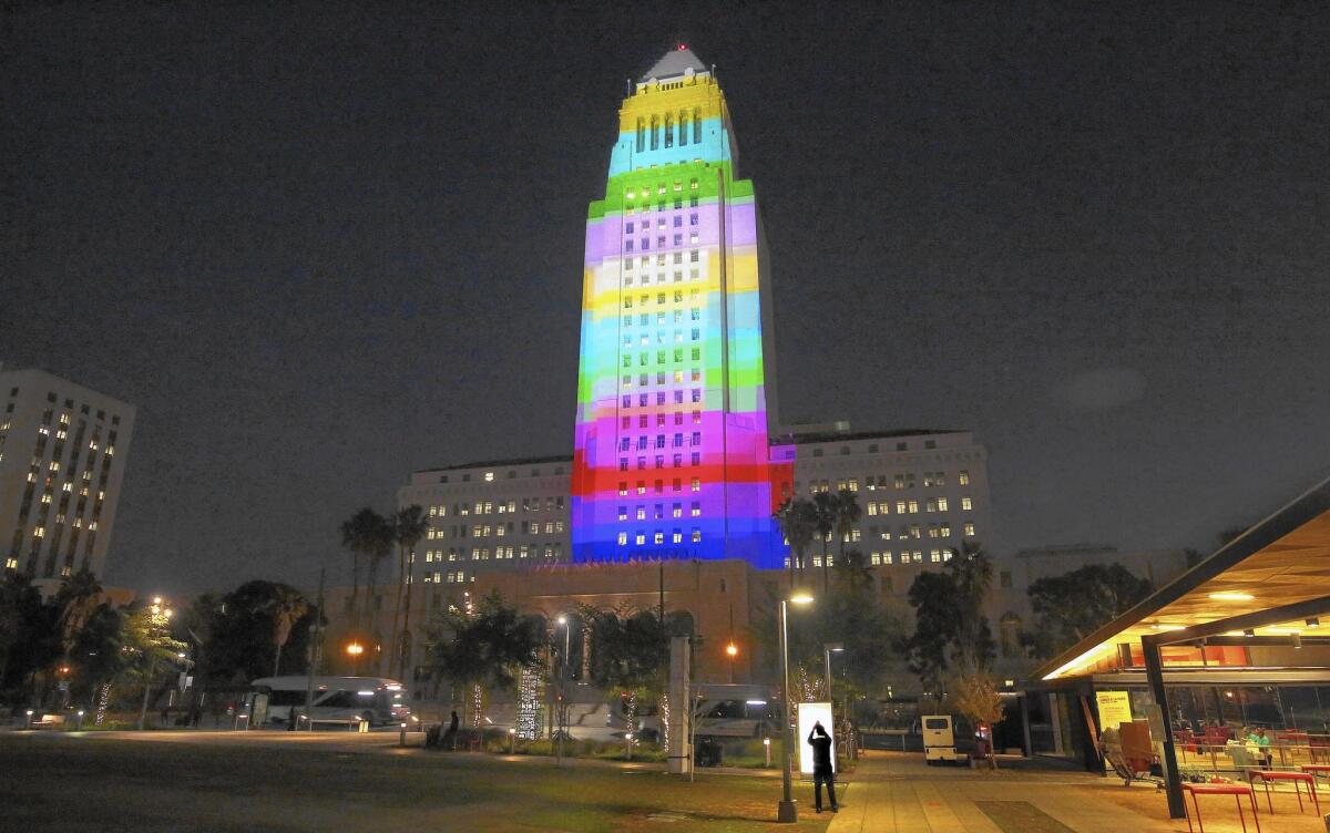 Colors are projected on the facade of City Hall during a test run Monday for a New Year's Eve celebration in Grand Park.