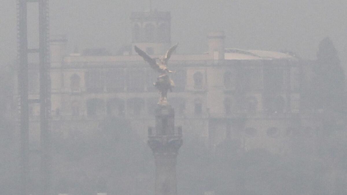 The Angel of Independence statue is nearly hidden by air pollution in Mexico City on May 15, 2019.