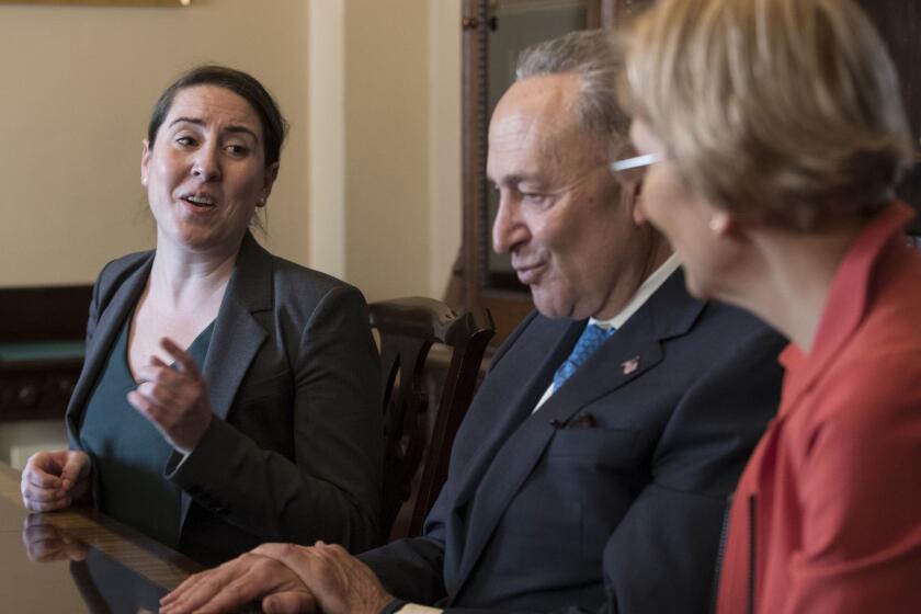 From left, Leandra English, who was elevated to interim director of the Consumer Financial Protection Bureau by its outgoing director, meets with Senate Minority Leader Chuck Schumer, D-N.Y., and Sen. Elizabeth Warren, D-Mass., to discuss the fight for control of the U.S. consumer watchdog's fate after President Donald Trump chose White House budget director Mick Mulvaney for the same post, on Capitol Hill in Washington, Monday, Nov. 27, 2017. (AP Photo/J. Scott Applewhite)