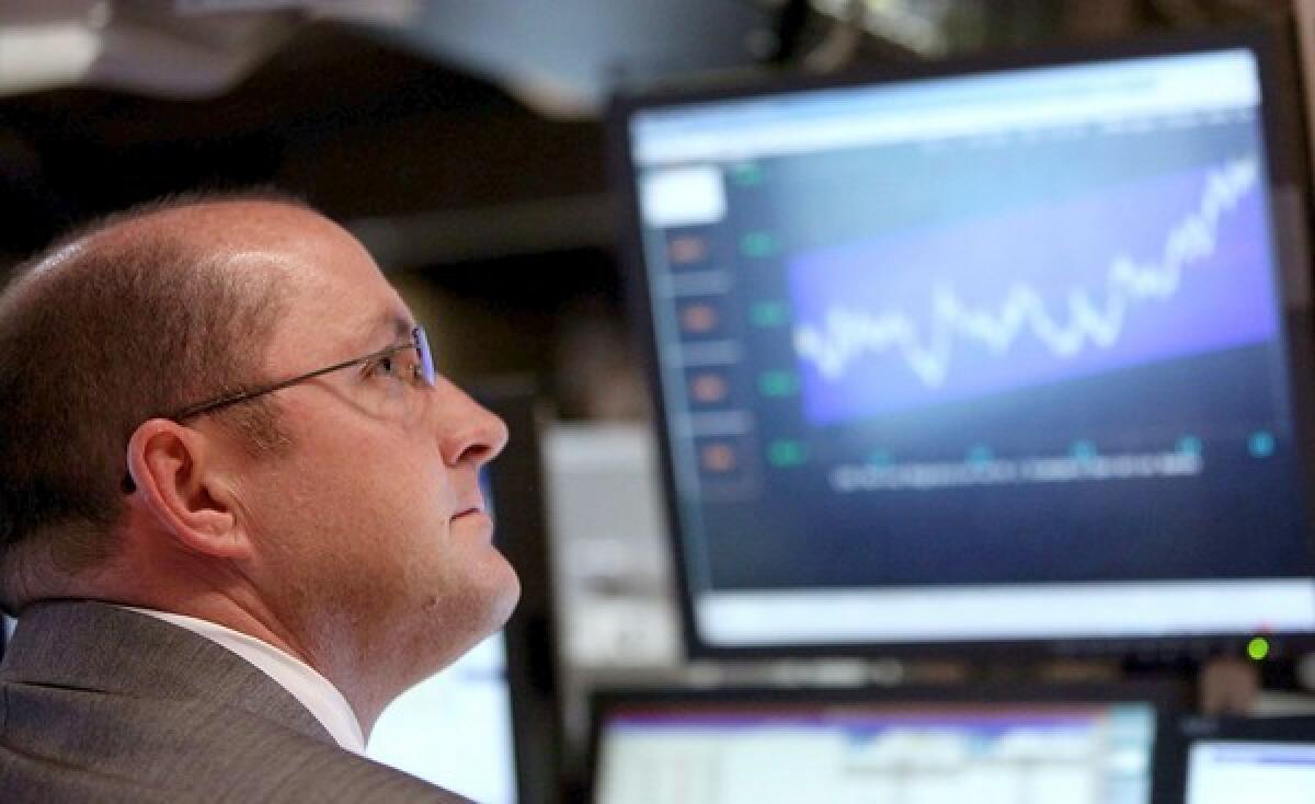 A trader works on the floor of the New York Stock Exchange before the closing bell. 