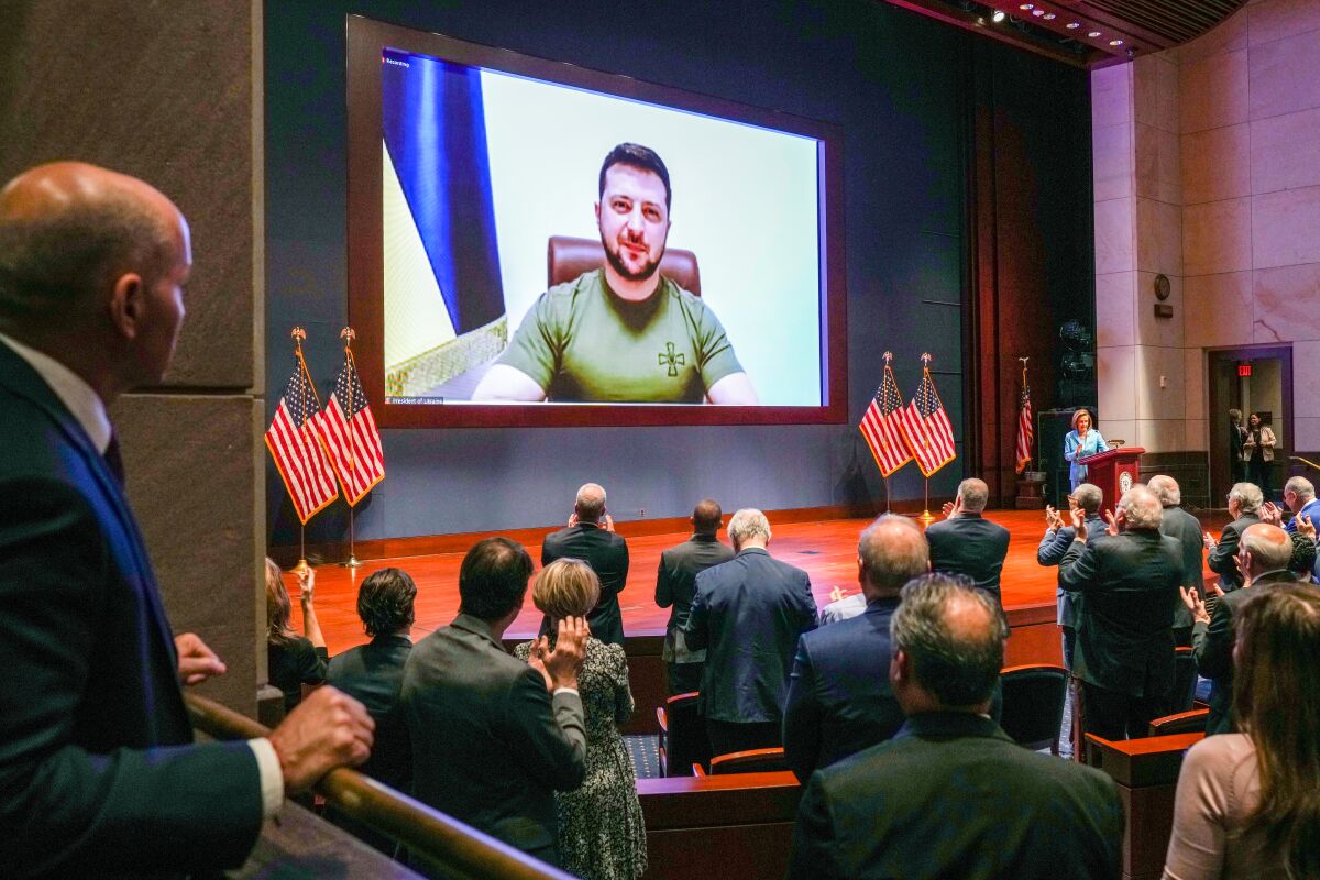 Volodymyr Zelensky appears on screen in front of members of Congress