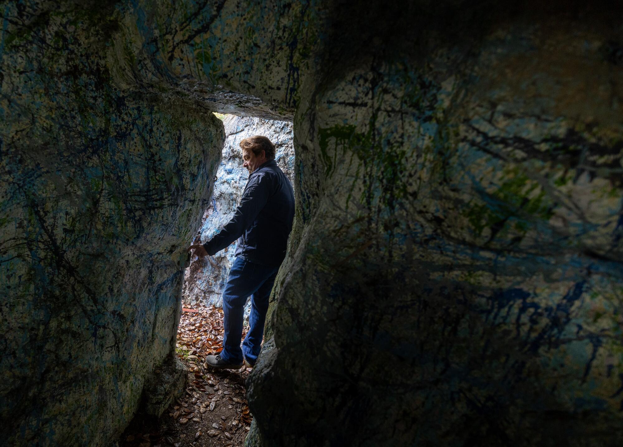 Tony Tucci stands at the entrance of a cave