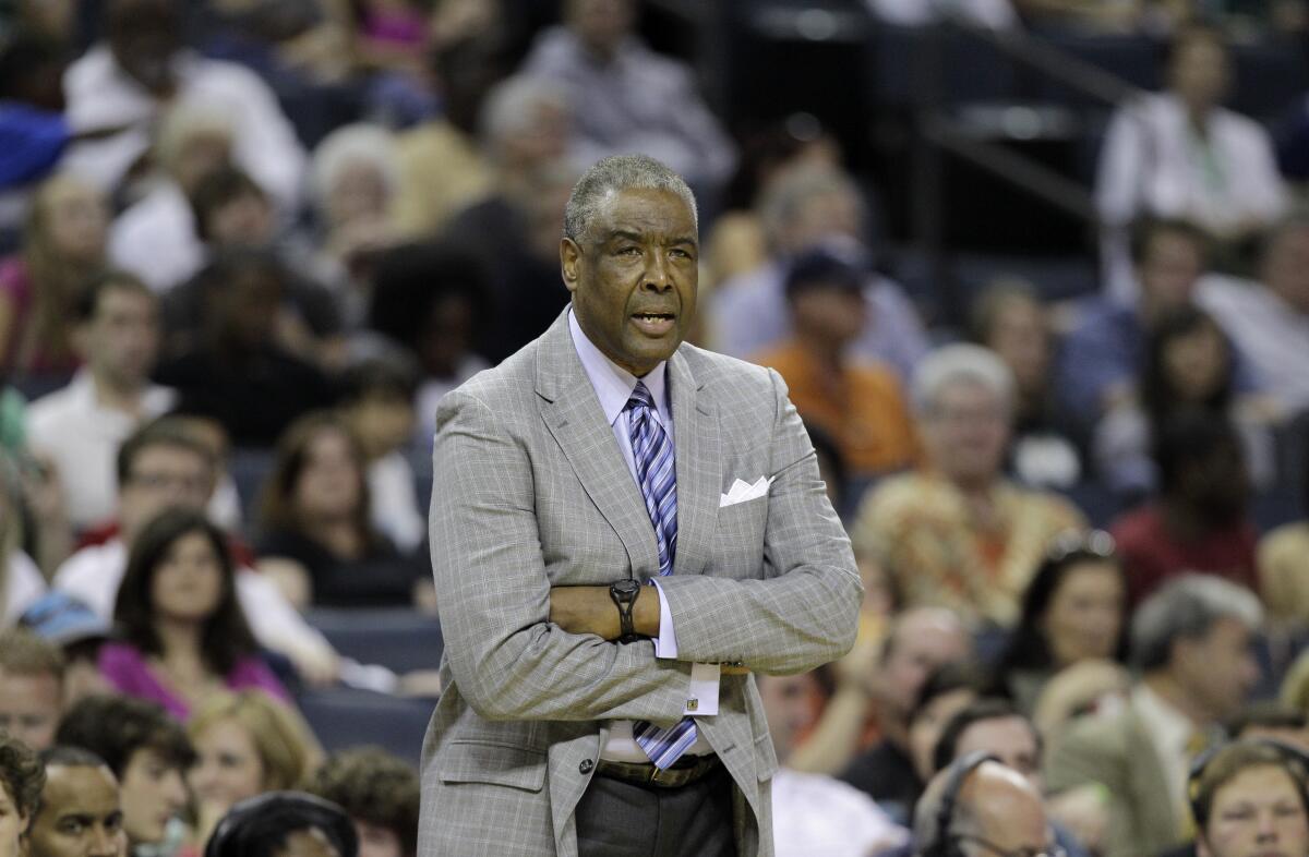 Charlotte Bobcats head coach Paul Silas looks on with his arms folded during a game.