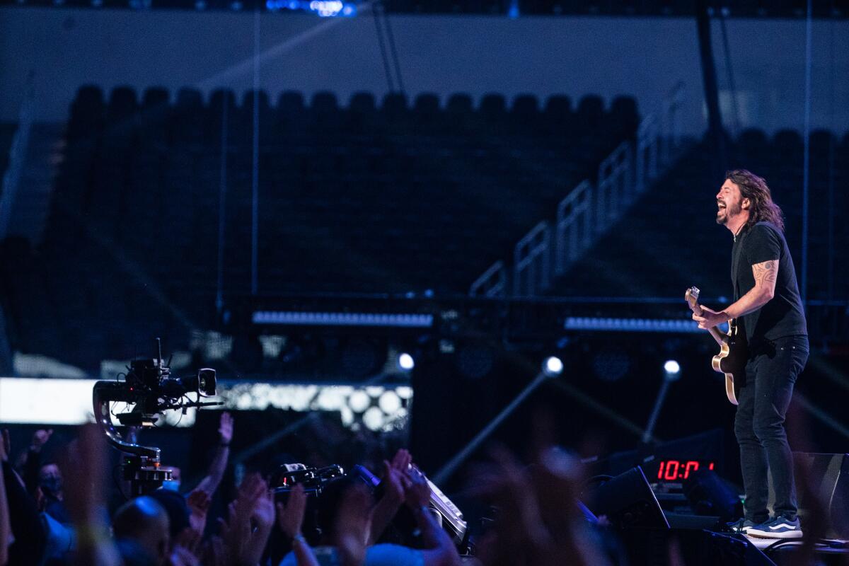 Dave Grohl plays guitar in concert at SoFi Stadium.