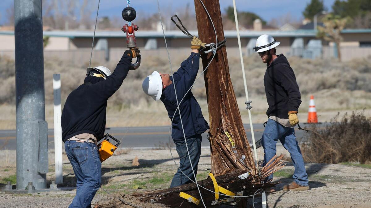 Edison crew repairs a power pole after an accident involving a school bus and a vehicle at East 20th Street and East Lancaster Boulevard Tuesday morning in Lancaster.