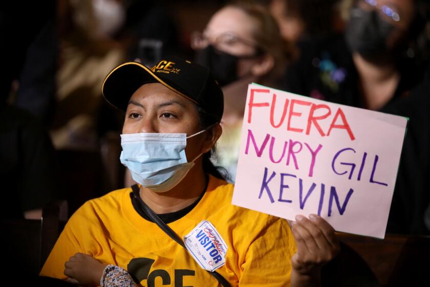 LOS ANGELES, CA - OCTOBER 11: Protestors at the Los Angeles City Council meeting in the Council Chamber at Los Angeles City Hall on Tuesday, Oct. 11, 2022 in Los Angeles, CA. Protestors want the resignation of Los Angeles Councilmembers Nury Martinez, Kevin de Leon and Gil Cedillo. Martinez made racist remarks about Councilmember Mike Bonin son in the recording as her colleagues, Councilmembers Kevin de Leon and Gill Cedillo, laughed and made wisecracks. (Gary Coronado / Los Angeles Times)