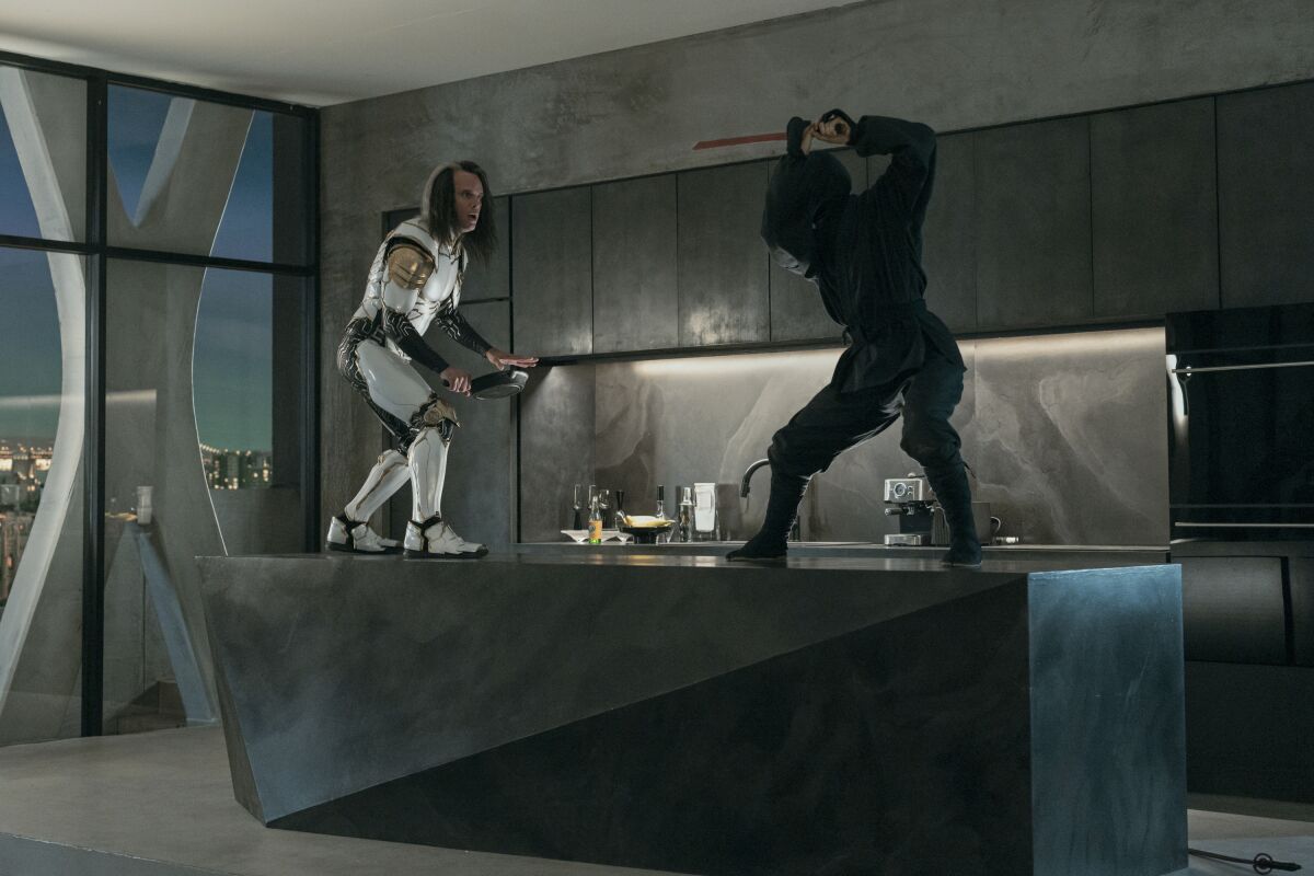 A man in white superhero armor battles a ninja dressed in black on top of a kitchen counter.