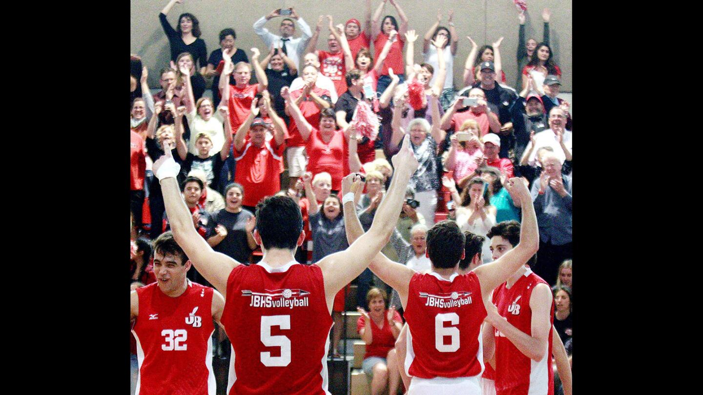 The Burroughs team celebrates with the fans after winning the final point to win the match against Sanger in a CIF Southern Section division II boys' volleyball semifinal match at Burroughs High School on Thursday, May 26, 2016. Burroughs won the match 3-0 and will play again on Saturday.