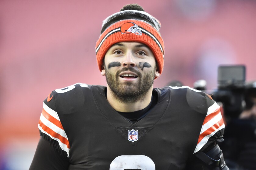 FILE - Cleveland Browns quarterback Baker Mayfield walks off the field after his team defeated the Baltimore Ravens in an NFL football game, Sunday, Dec. 12, 2021, in Cleveland. Mayfield and coach Kevin Stefanski tested positive for COVID-19 on Wednesday, Dec. 15, and will likely miss Saturday’s game against the Las Vegas Raiders as Cleveland deals with a widespread outbreak during its playoff pursuit. (AP Photo/David Richard, File)