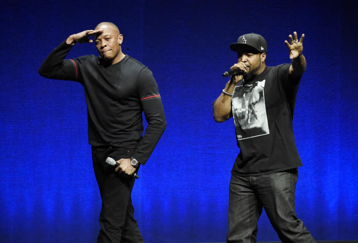 Dr. Dre, left, and Ice Cube, original members of the hip-hop group N.W.A, salute the crowd at CinemaCon 2015 in Las Vegas in April.