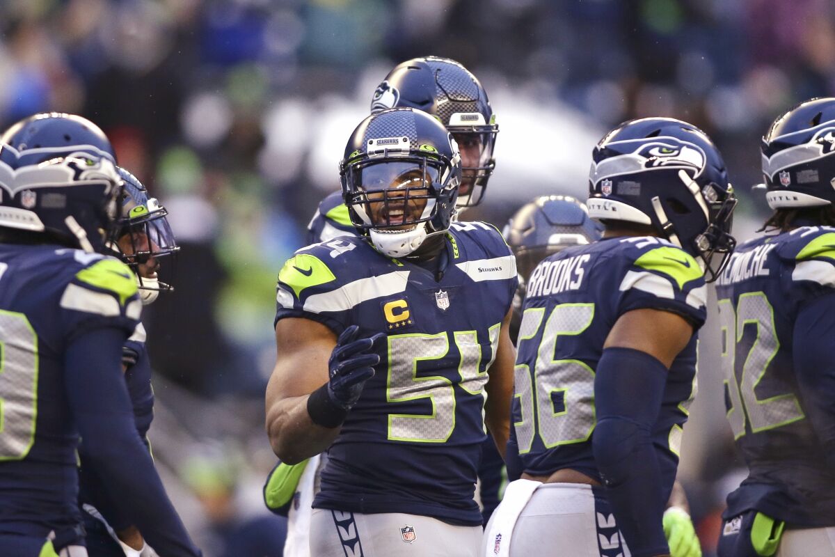 Seattle Seahawks middle linebacker Bobby Wagner stands with teammates.