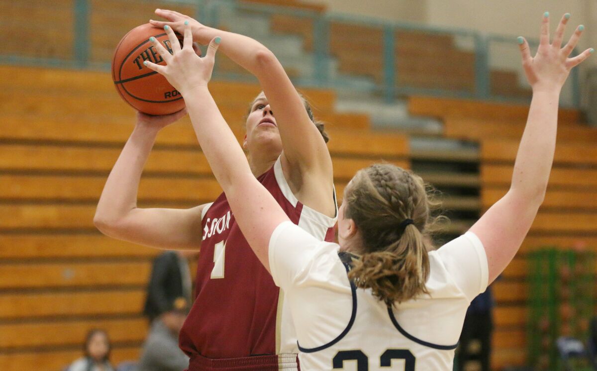 Mission Hills' Amber Schmidt powers to the hoop against LCC's Haley Dumiak.