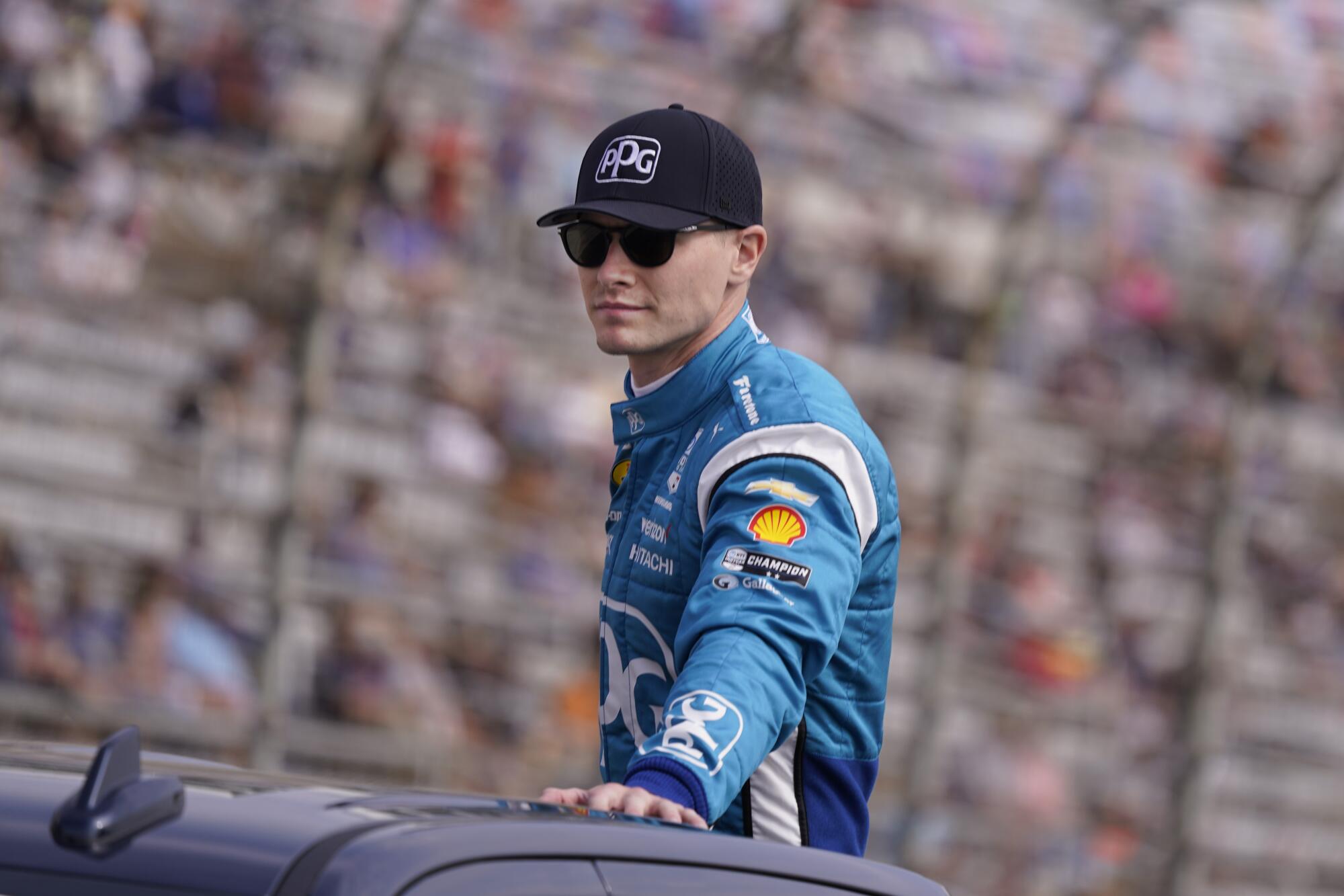 Josef Newgarden rides atop a truck during introductions for the IndyCar race at Texas Motor Speedway.