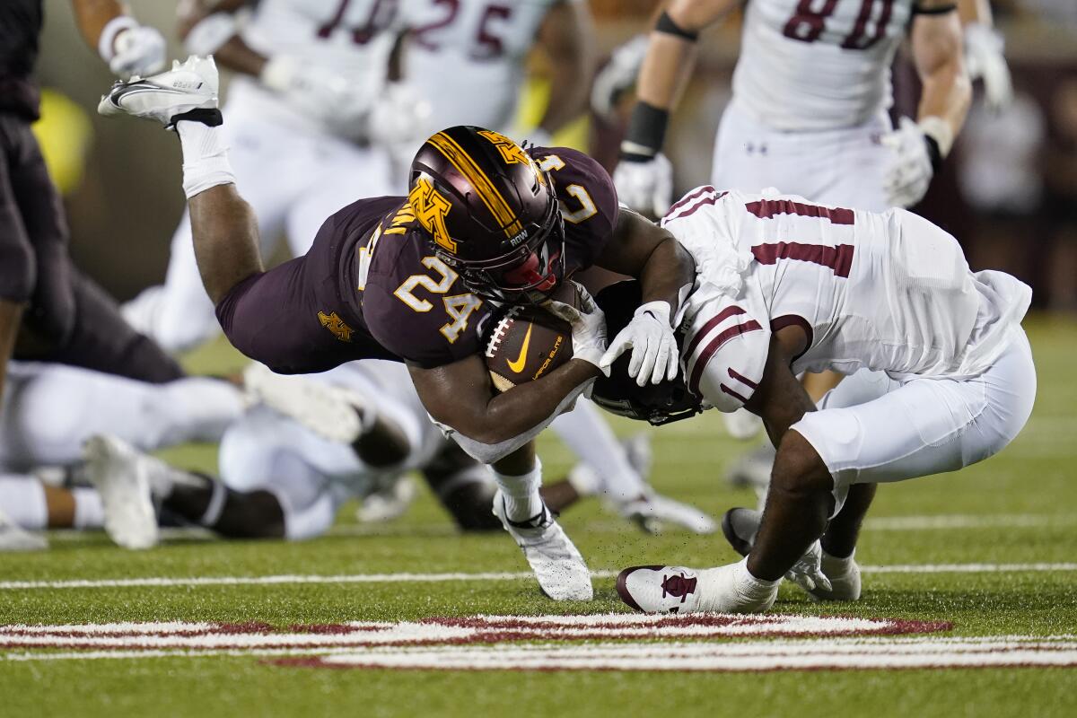 Minnesota running back Mohamed Ibrahim, left, is tackled by New Mexico State defensive back Dylan Early during the first half of an NCAA college football game Thursday, Sept. 1, 2022, in Minneapolis. (AP Photo/Abbie Parr)