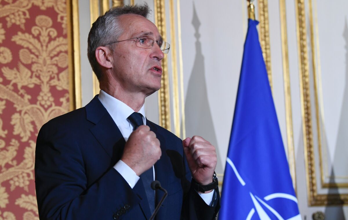 NATO Secretary General Jens Stoltenberg, left, attends media conference with French Foreign Minister Jean-Yves Le Drian and French Defence Minister Florence Parly in Paris, Friday, Dec. 10, 2021. (Bertrand Guay/Pool Photo via AP)