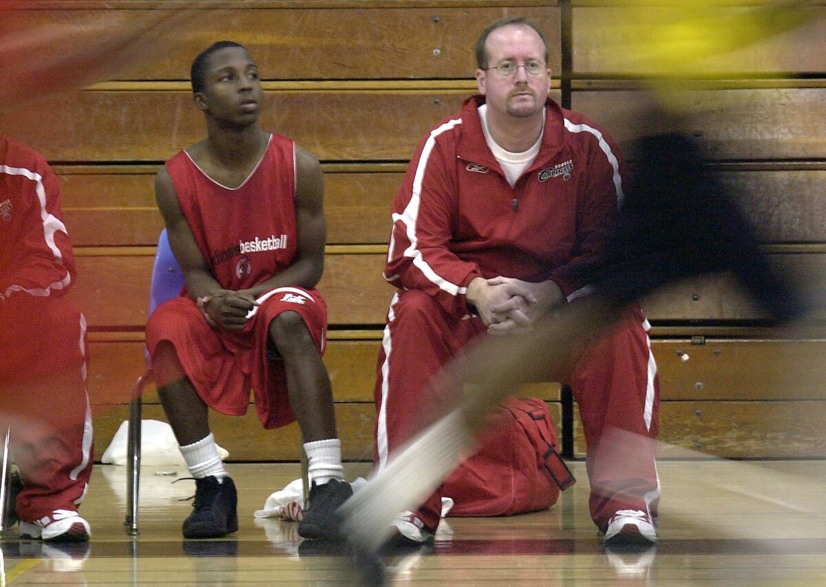 Hoover High's JayDee Luster sits with coach Ollie Goulston during a 2003 scrimmage.