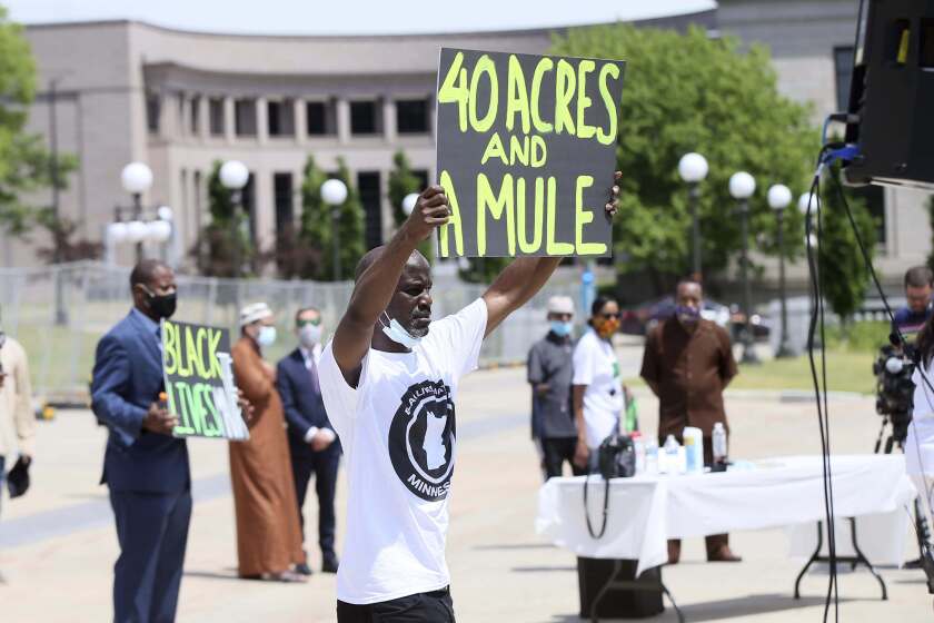People demonstrate at the Minnesota State Capitol in St. Paul, Minn. on Friday, June 19, 2020, to mark Juneteenth, the day in 1865 when federal troops arrived in Galveston, Texas, to take control of the state and ensure all enslaved people be freed, more than two years after the Emancipation Proclamation. (AP Photo/Jim Mone)