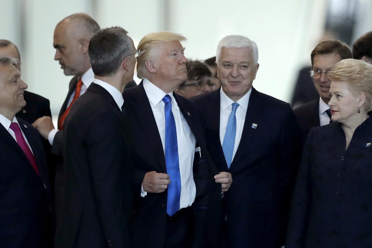Montenegrin Prime Minister Dusko Markovic, center right, after apparently being pushed by President Trump during a NATO summit in Brussels.