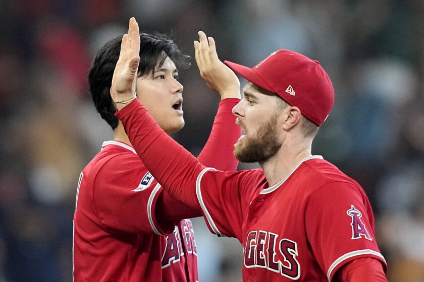 Los Angeles Angels' Shohei Ohtani, left, and Jared Walsh celebrate after a baseball game against the Houston Astros Sunday, June 4, 2023, in Houston. The Angels won 2-1. (AP Photo/David J. Phillip)