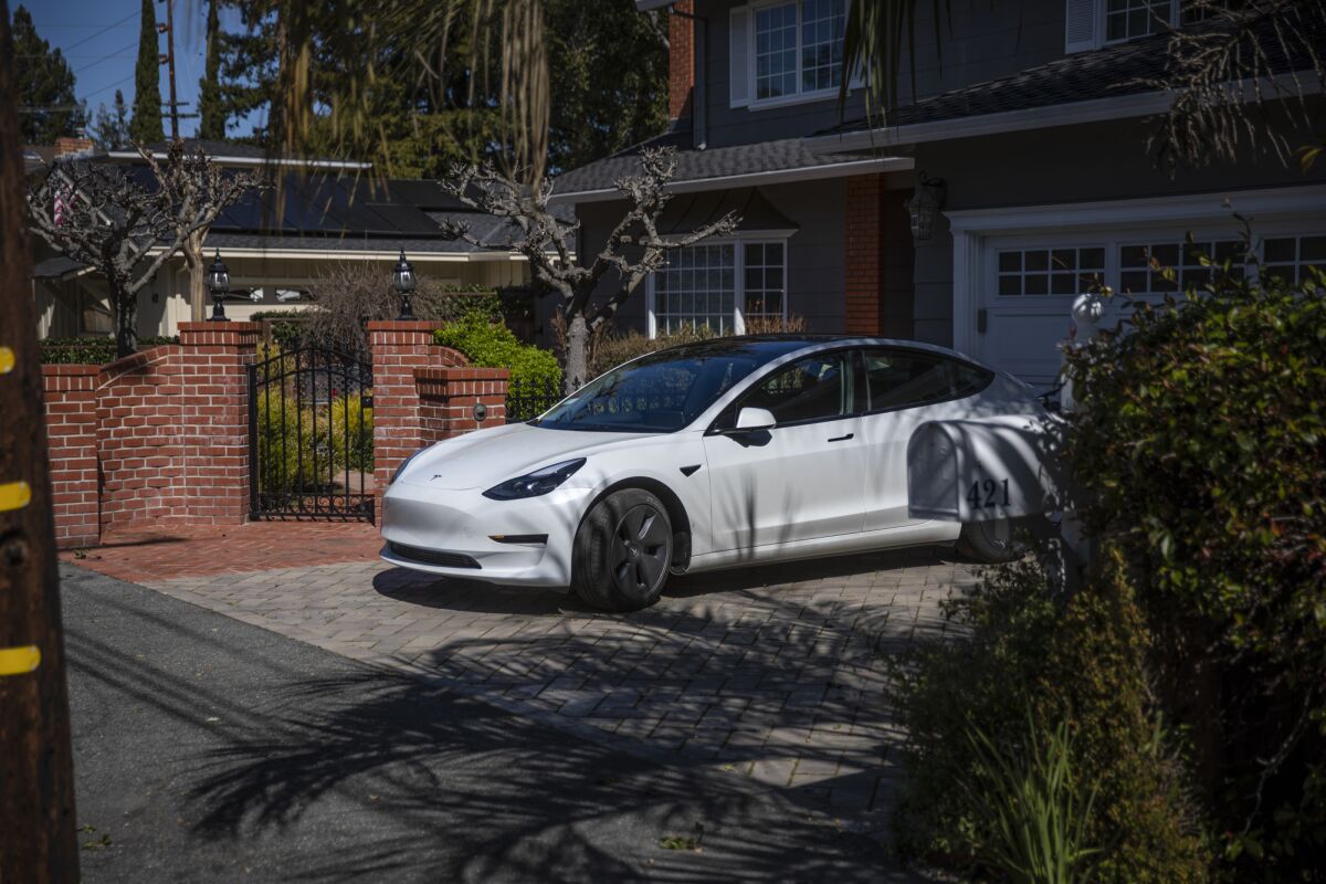 An electric vehicle parked in front of a home in Atherton on March 16, 2023. Photo by Martin do Nascimento