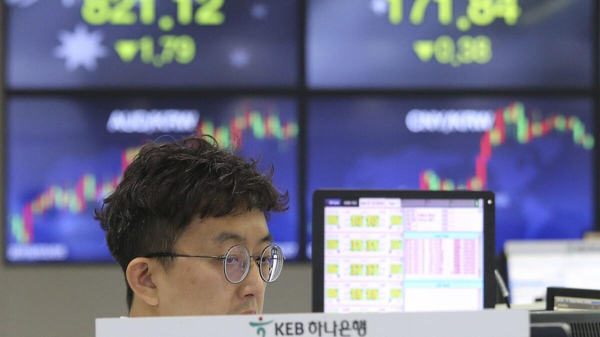 A currency trader watches monitors at the foreign exchange dealing room of the KEB Hana Bank headquarters in Seoul on Monday.