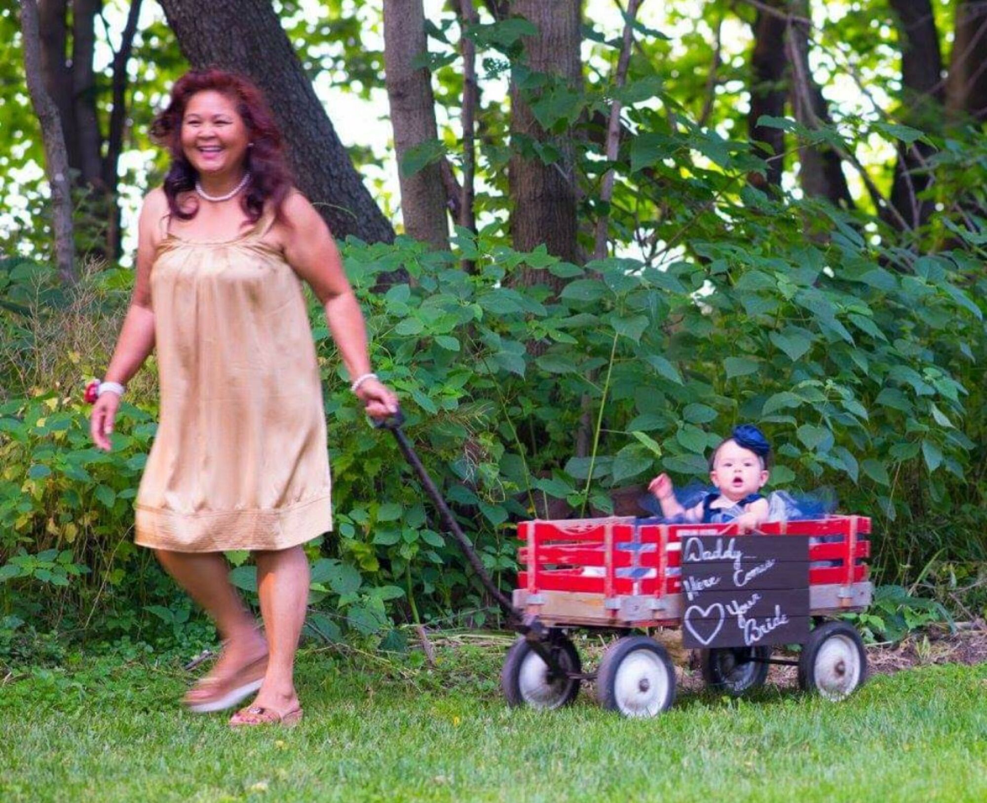 Judy Bounthong pulls granddaughter Ember in a wagon at her son William’s 2017 wedding in Wisconsin.