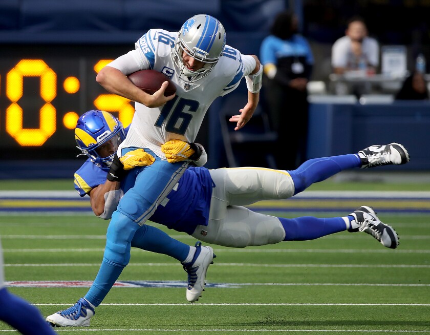 Detroit Lions quarterback Jared Goff is brought down by Rams linebacker Kenny Young.