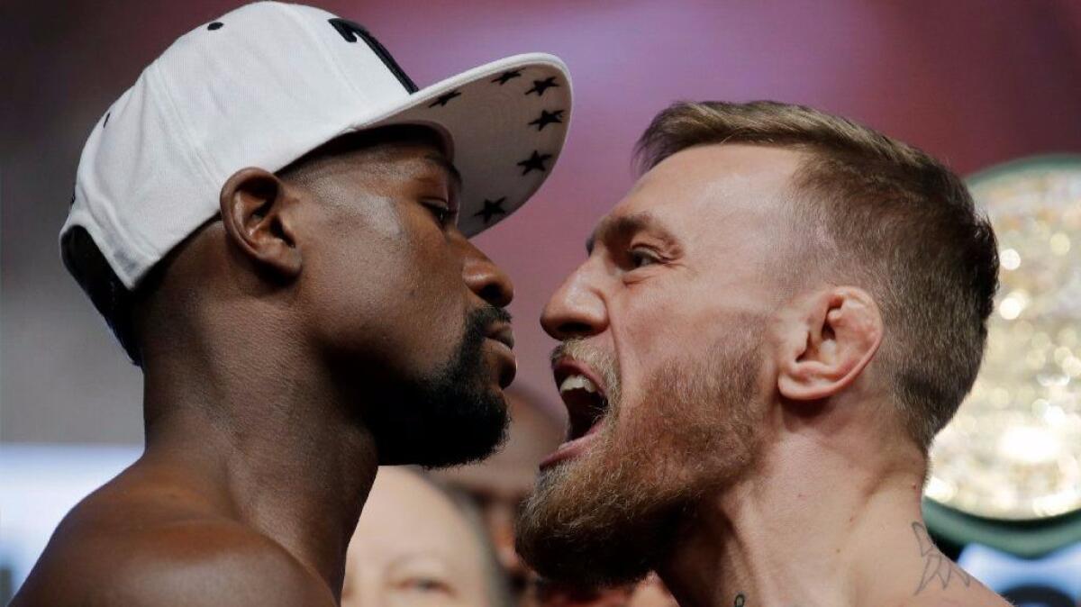 Floyd Mayweather Jr. and Conor McGregor face off during their weigh-in Aug. 25 in Las Vegas.