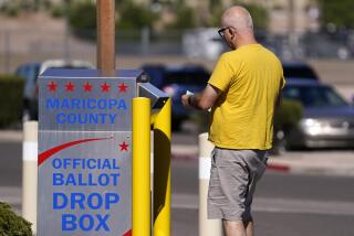 A voter places a ballot in an election voting drop box in Mesa, Ariz., Friday, Oct. 28, 2022. (AP Photo/Ross D. Franklin)