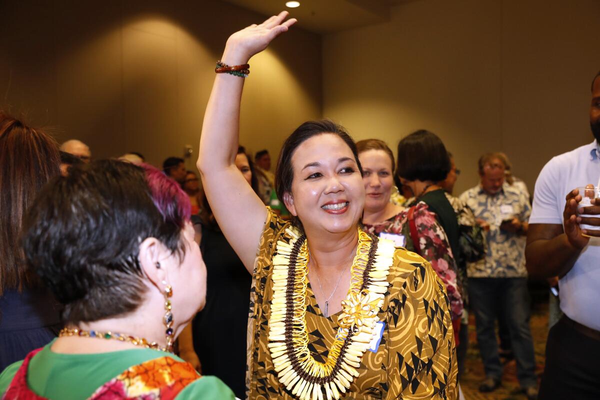Jill Tokuda, Democratic candidate in Hawaii's 2nd Congressional District, waves during a Democratic gathering on election nigght Tuesday, Nov. 8, 2022, in Honolulu. (AP Photo/Marco Garcia)