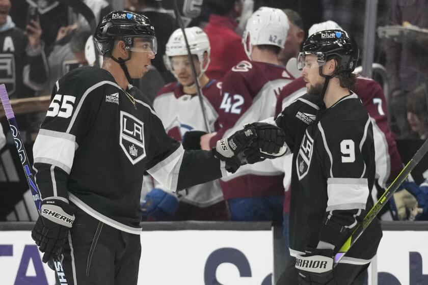 Los Angeles Kings center Quinton Byfield (55) celebrates with center Adrian Kempe (9) after scoring.