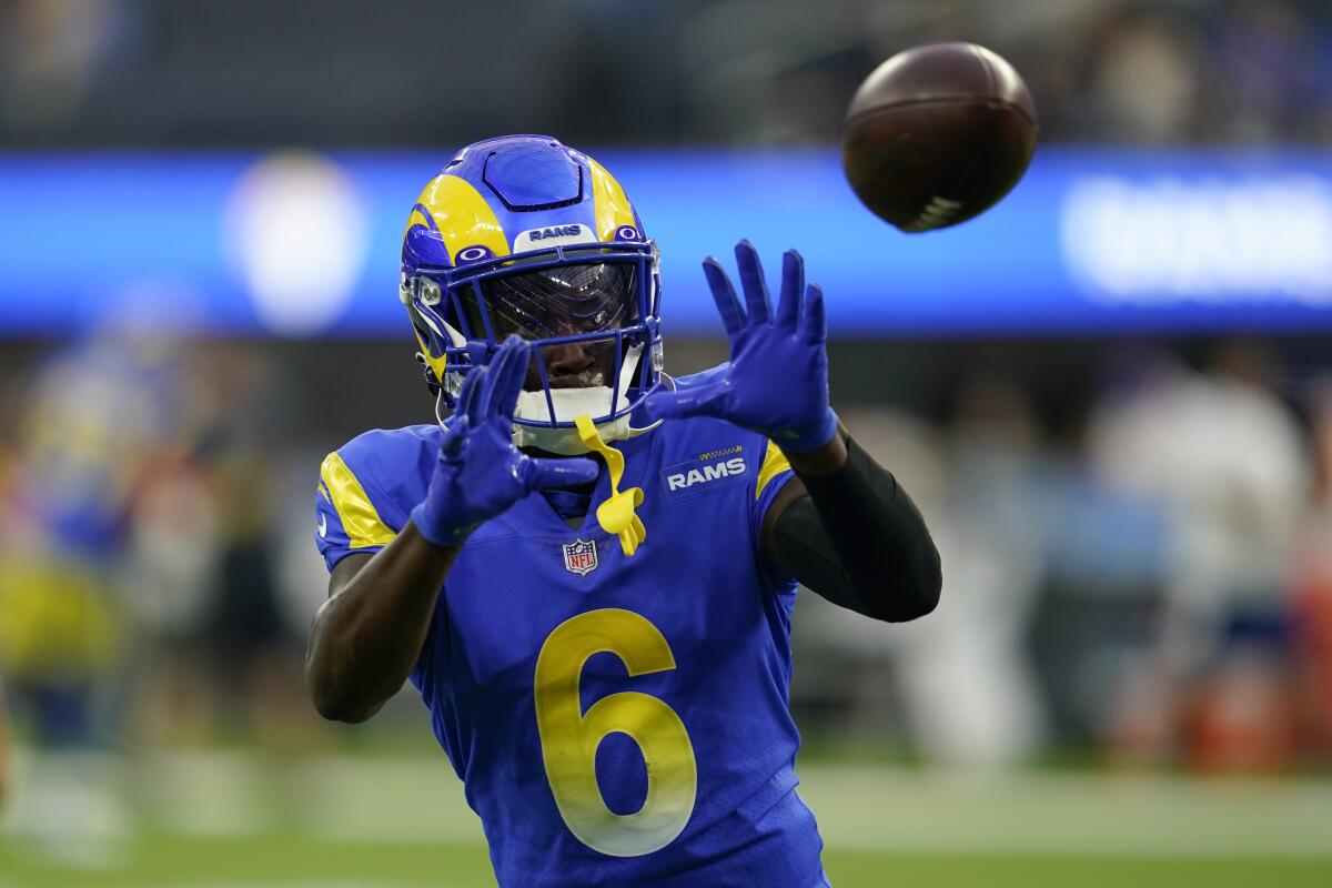 Rams cornerback Derion Kendrick catches a pass as he warms up before a game.